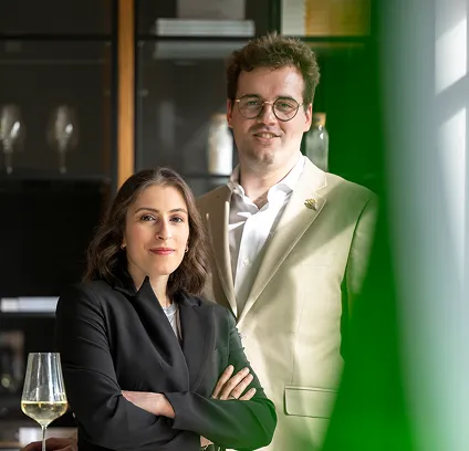 Ons team staat voor u klaar! Twee glimlachende professionals, een man en een vrouw, staan klaar voor contact.